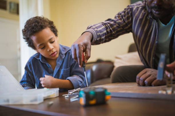 istock Father and his children doing some DIY work at home 1156715220