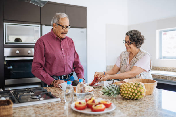 istock Senior couple eating snack in the modern kitchen. 1156718377