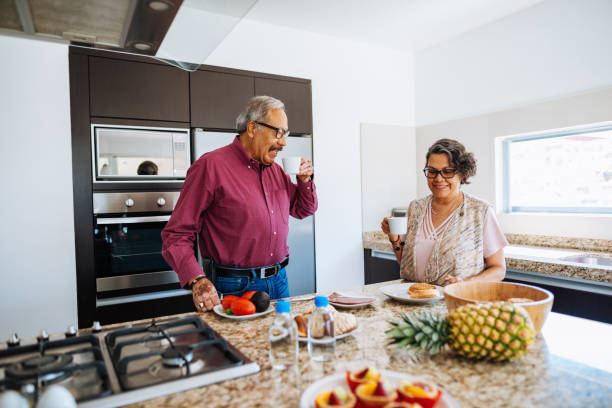 istock Senior couple drinking morning coffee and eating light organic breakfast. 1156718459