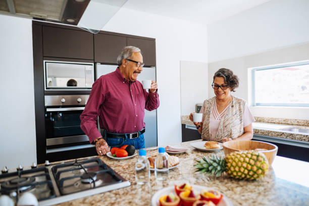 istock Senior Latin couple having breakfast and smiling. 1156718491