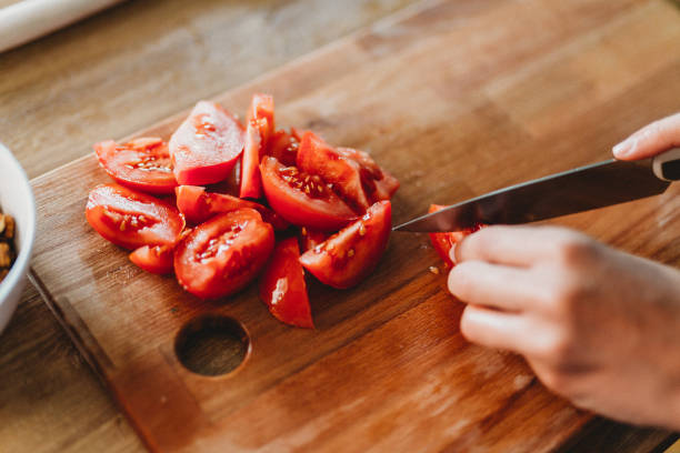 Preparing food Woman cutting fruit in the kitchen chop stock pictures, royalty-free photos & images