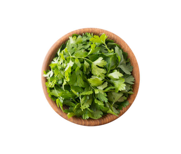 istock Parsley isolated on white background. Top view. Parsley leaves with copy space for text. Herbs isolated on white. Parsley leaves on white background. 1156719421