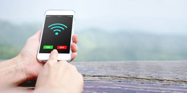 istock Female hand holding mobile phone with charged battery on screen 1156720978