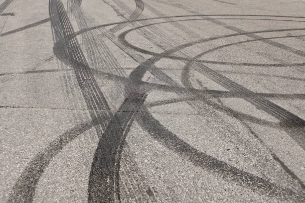 Tire abrasion on asphalt after a illegal car racing Tire abrasion on asphalt after a illegal car racing street skid marks stock pictures, royalty-free photos & images