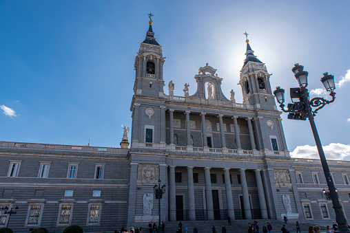 People walking on the Plaza de la Armería next to the Almudena Cathedral at downtown Madrid city, Spain