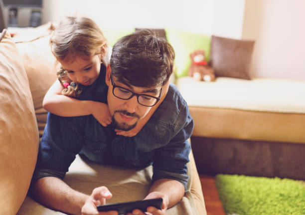 istock Father and daughter enjoying at home 1156725802