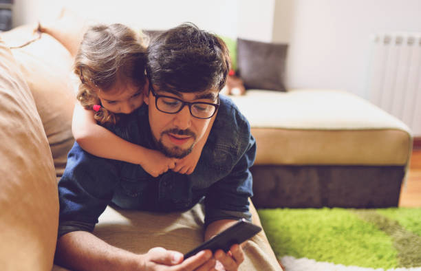 istock Father and daughter enjoying at home 1156725823
