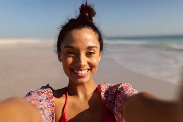 istock Young woman in bikini standing on the beach 1156727536