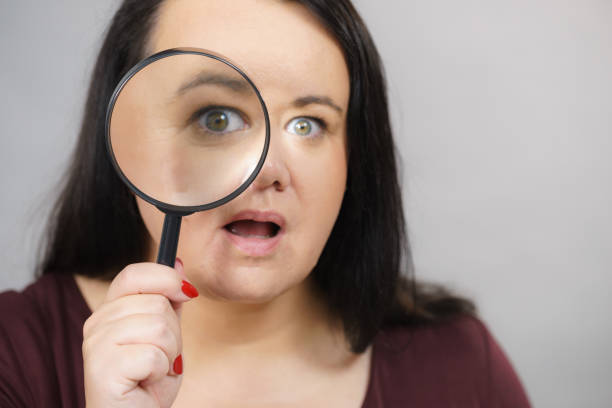 istock Adult woman with magnifying glss 1156727913