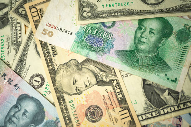 istock US dollar stack and Chinese yuan banknotes on the table The concept of a trade war between the United States and China 1156728572