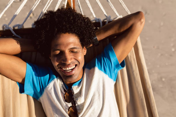 istock Man sleeping in a hammock on the beach 1156728727