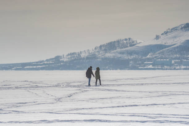 istock Winter landscape: an icy lake surrounded by mountains 1156729299