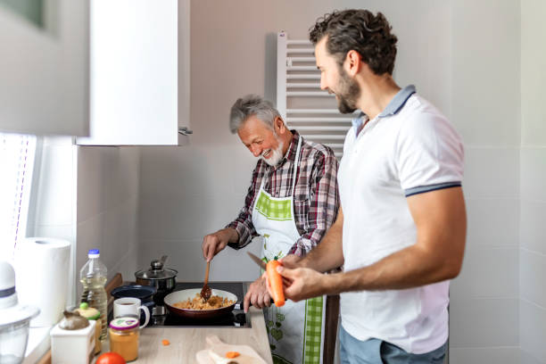 istock Hipster son with his senior father cooking 1156730092