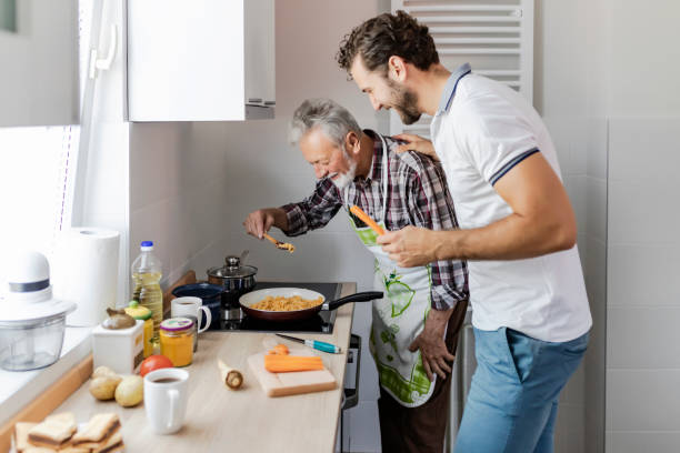 istock Hipster son with his senior father preparing lunch 1156731182