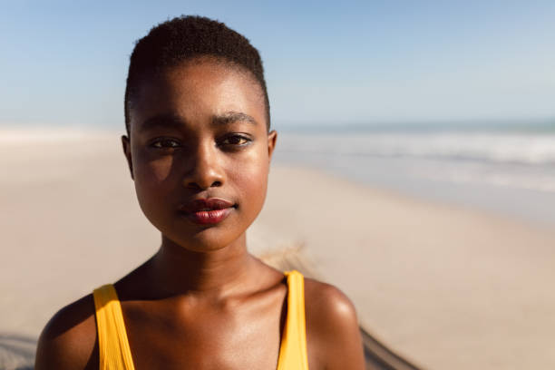 istock Young woman standing on the beach 1156731286