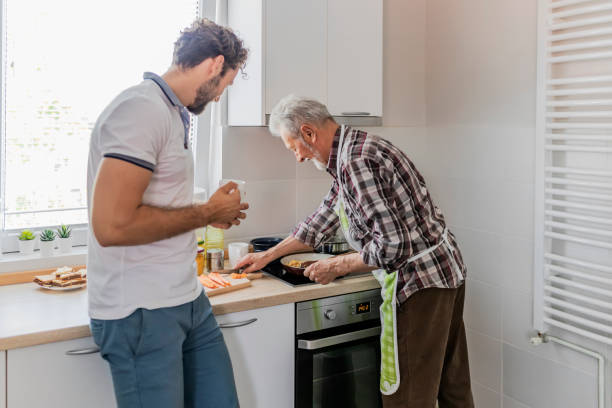 istock Hipster son with his senior father preparing lunch 1156731532