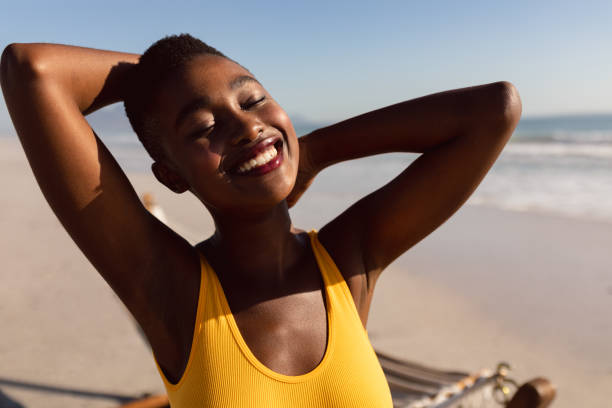istock Young woman standing on the beach 1156731563