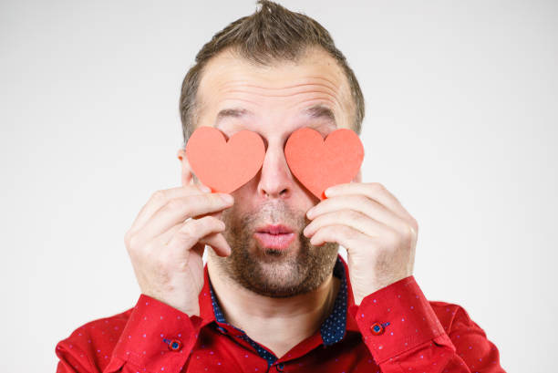istock Man in love with hearts on eyes 1156731575