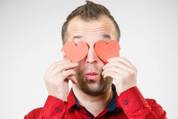 istock Man in love with hearts on eyes 1156732211