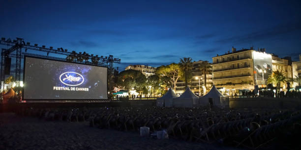 public viewing cannes,France - May 21,2019, the annual Cannes Film Festival is one of the world’s great film festivals, public event: a huge outdoor film screen, people watching free movies on the beach cannes film festival stock pictures, royalty-free photos & images