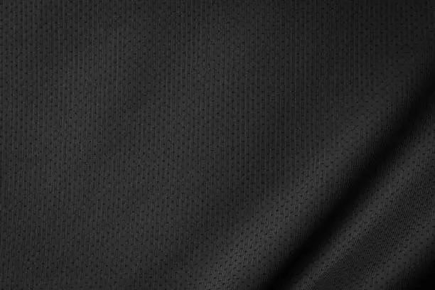 Photo of Black jersey texture background. Detail of luxury fabric surface.