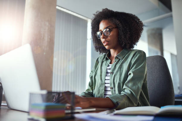 istock Creative businesswoman writing using laptop at office desk 1156733673