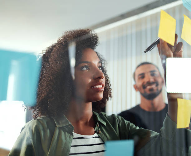 istock Office colleagues writing business ideas and plans on sticky not 1156733806