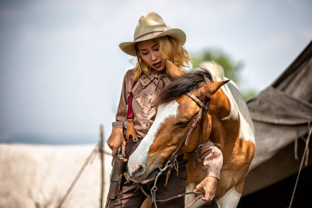 istock Woman Standing By Horse 1156734621