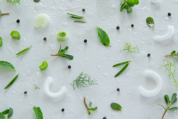 Composition of fresh green vegetables and herbs on white background. Vegetable salad ingredients. Creative food pattern. Flat lay