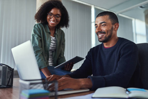 istock Smiling creative colleagues working together in the office 1156736737