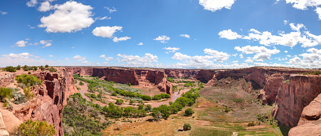 Canyon de Chelly, Arizona, Navajo nation, United States. Panoramic view of the red rocks and the river, blue sky background