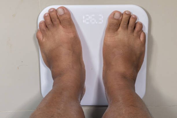 istock close up of man feet and digital smart scale 1156743398
