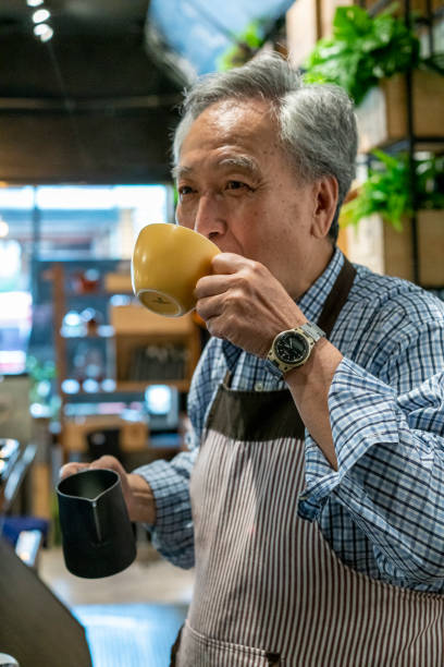 istock Senior barista drinking latte 1156746823