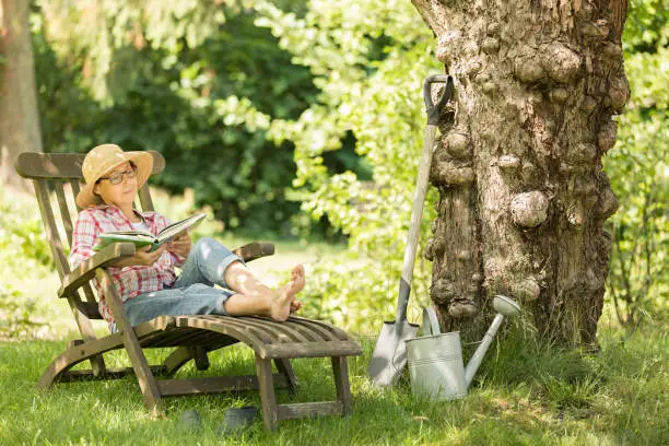 Photo of Gardening - senior woman in deck chair enjoy relaxing in garden outdoors