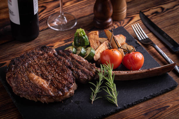 istock grilled tomahawk ribeye steak on black stone plate 1156753957