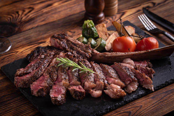 istock grilled tomahawk ribeye steak on black stone plate 1156754952