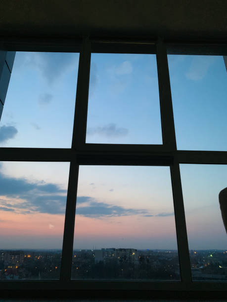 istock Panoramic windows overlooking beautiful golden sunset. View from home window 1156755649