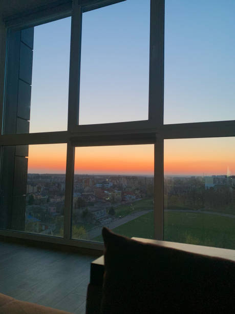 istock Panoramic windows overlooking beautiful golden sunset. View from home window 1156755665