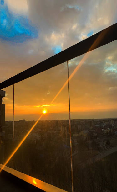 istock Panoramic windows overlooking beautiful golden sunset. View from home window 1156756137