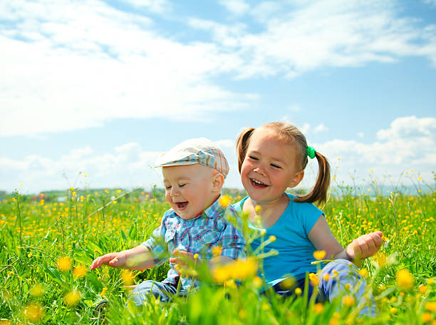 istock Two children are having fun on green meadow 115675691