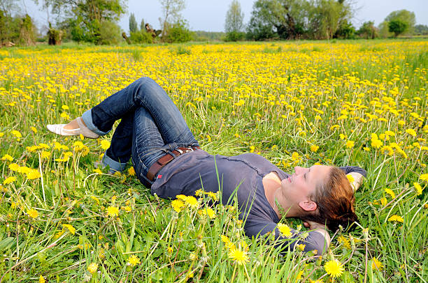 istock woman lies on a flower meadow 115675780