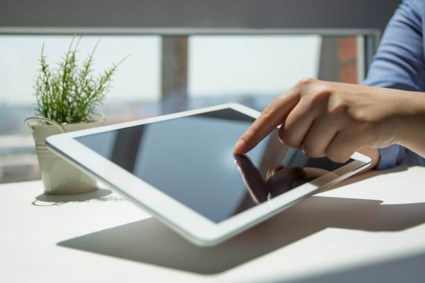 istock Close up of woman hand's using tablet touch screen 1156760260