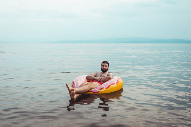 istock Man with an inflatable ring at the seaside 1156760615