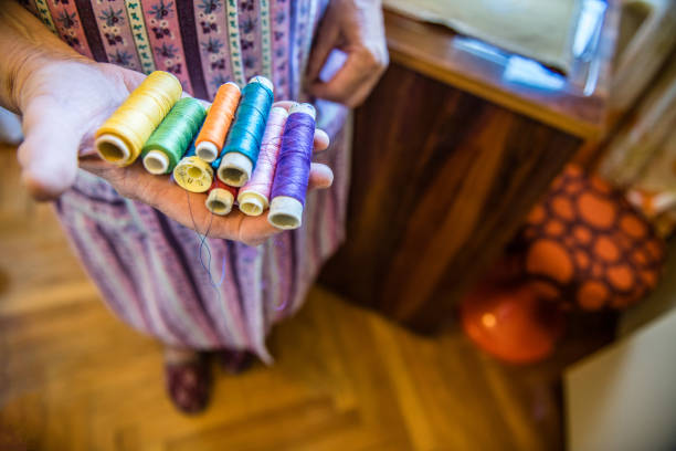 istock Senior Woman holding Cotton Thread in her Hands 1156763441