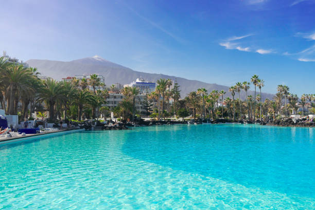 skyline of Puerto Cruz, Tenerife, Spain skyline of Puerto de la Cruz town with Teide volcano and pool, Tenerife, Spain puerto de la cruz tenerife stock pictures, royalty-free photos & images