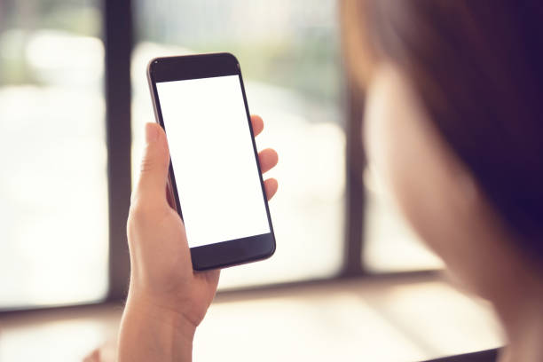 istock Mockup image of hand holding mobile phone with blank white screen, copy space. 1156767460
