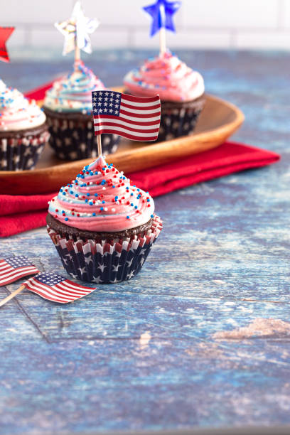 istock American Themed Cupcakes with Flags on a Blue Wooden Table 1156769992