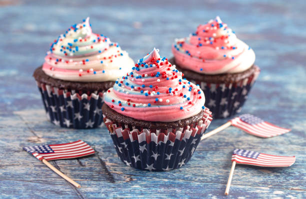 istock American Themed Cupcakes with Flags on a Blue Wooden Table 1156770001