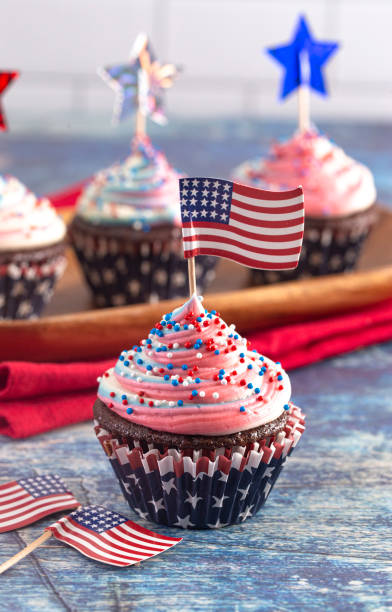 istock American Themed Cupcakes with Flags on a Blue Wooden Table 1156770165
