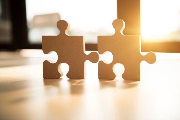 istock Connecting jigsaw puzzle with sunlight effect, Business solutions, success and strategy concept. 1156770298